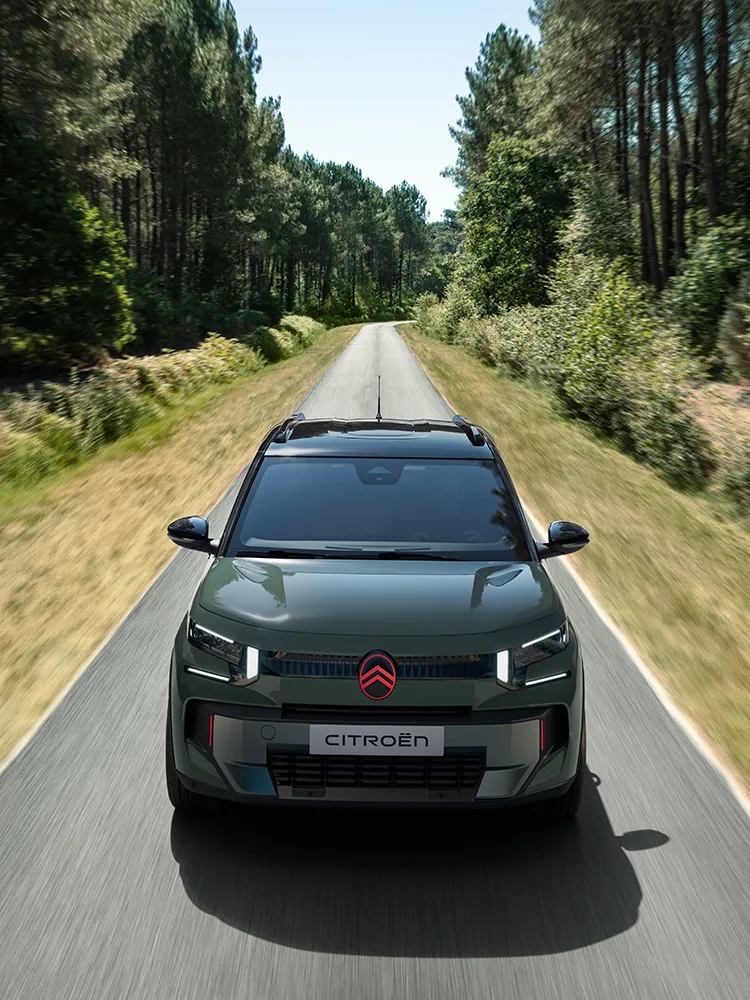 Top front view Citroën ëC3 Outdoor with LED signature shows Advanced Comfort compact SUV on forest road