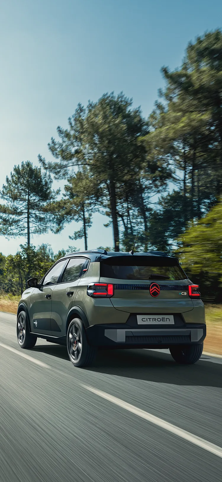 Rear three-quarter view Citroën ëC3 Outdoor with LED taillights shows Advanced Comfort SUV on open road
