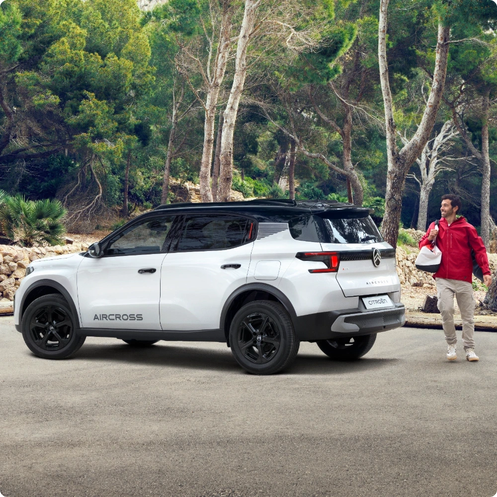 Driekwart achteraanzicht van de Citroën ë‑C3 Aircross elektrische SUV in buitenomgeving, met nadruk op een grotere actieradius voor zelfverzekerde, efficiënte en betaalbare mobiliteit.