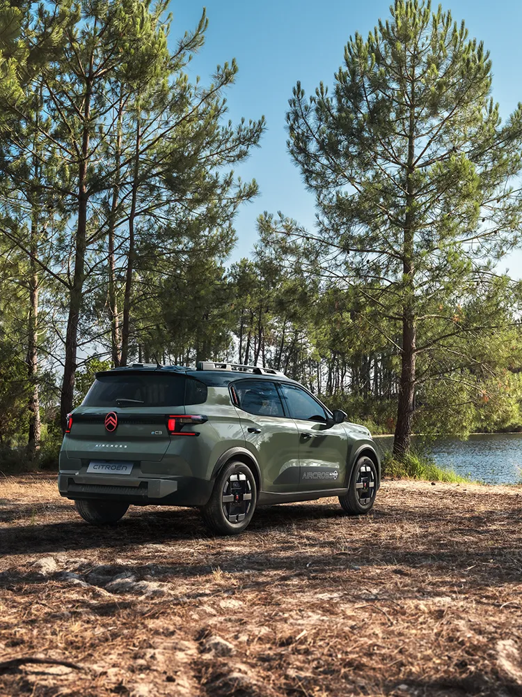 Rear three-quarter view Citroën C3 Aircross SUV shows LED signature, Advanced Comfort, family SUV on forest road
