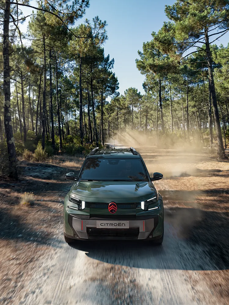 Aerial front view Citroën C3 Aircross SUV shows LED signature, Advanced Comfort, family SUV on forest trail