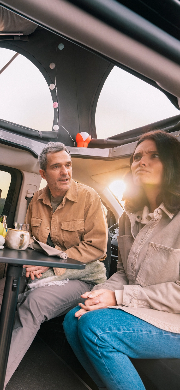 Een groep mensen dineert samen in een Citroën camper van